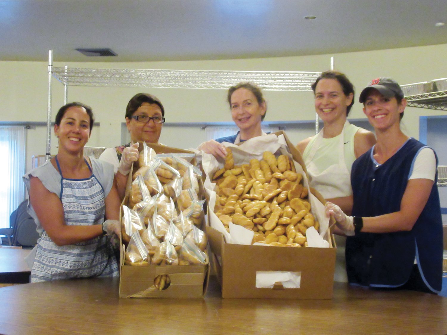 PROUD PACKERS: Ladies like Kassiane Campopiano, Kathy Grammas, Nancy Harritos, Tina Liakos and Tricia Rougas help package some of the 40,000 pastries that will be featured at the 36th annual Cranston Greek Festival.